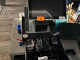 a laptop computer sitting on top of a glass desk