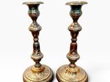 pair of antique brass candlesticks on a white background