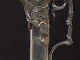 an antique silver plated glass vase with a handle and handle