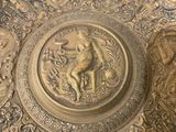 a gold plate with a picture of a man on it