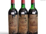 three bottles of wine sitting next to each other on a white surface