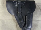 a black leather holster with a belt on it