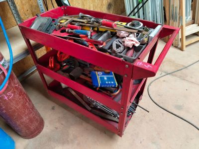 a red work cart with a lot of tools on it