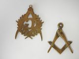 two masonic symbols are shown on a white surface