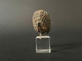 a small piece of rock on a clear stand