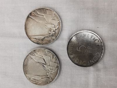 three coins sitting next to each other on top of a table
