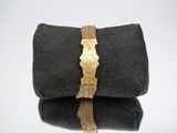a black bag that has a gold buckle on it
