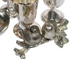 a silver cup with a bird on it next to other silver cups