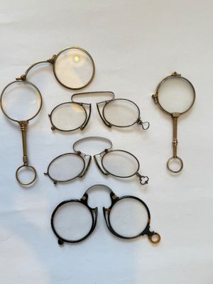 a lot of glasses and a magnifying glass on the table