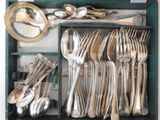 a tray with silverware and spoons in it