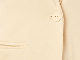 a close up of a man wearing a beige suit and a white shirt