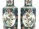 pair of chinese vases with birds and flowers painted on them