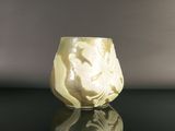 a white vase sitting on top of a black table