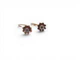 a pair of brown and white diamond stud earrings on a white background