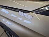 a sticker on the hood of a car that has been painted