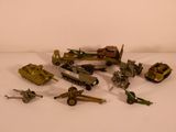 a lot of toy army vehicles on a white surface