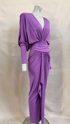 a purple dress on a mannequin stand with a white background