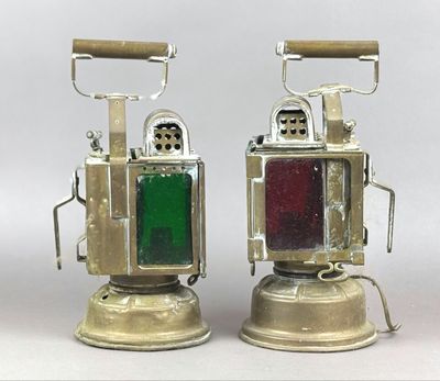 two old fashioned lamps that are sitting on a table