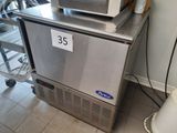 a microwave sitting on top of a refrigerator in a kitchen