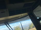 looking out the window of a small airplane at a grassy field
