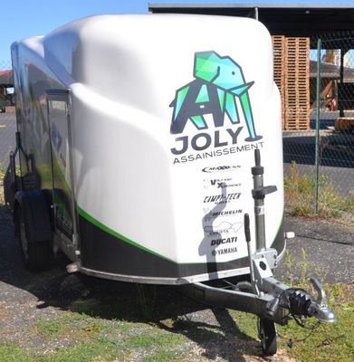 a trailer that is parked on the side of the road