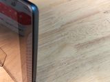 a cell phone sitting on top of a wooden table
