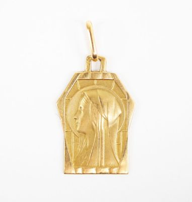 an image of a gold pendant with an image of jesus on it