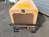 a small yellow machine that is sitting on the ground