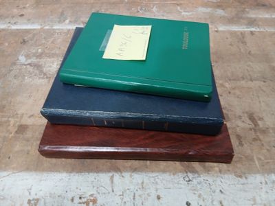 three books stacked on top of each other on a table