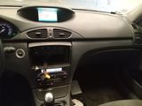 the interior of a car with a steering wheel and dashboard controls