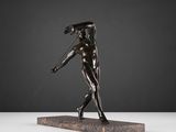 a bronze statue of a man holding a baseball bat on a marble base