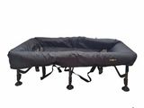 a close up of a bed with a black cover on it