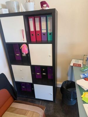 un bureau avec une chaise et une bibliothèque dans un coin