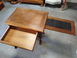 a wooden table with a drawer underneath it in a room