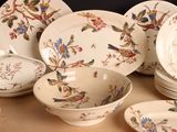 many plates and bowls that are sitting on a table