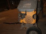 a small machine that is sitting in a barn