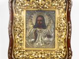 an old picture of jesus in a gold frame on a white wall