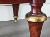 a close up of the legs of a bed with a clock on it