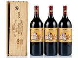three bottles of red wine in a wooden box next to a wooden box