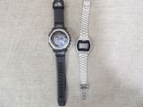 two watches that are sitting next to each other on a table