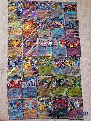 a pile of pokemon cards sitting on top of a table
