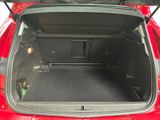 the back of a red car with its trunk open showing the cargo compartment