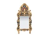 un miroir ouvragé avec un cadre doré sur fond blanc