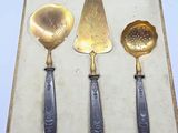 three spoons and a spatula sitting in a box