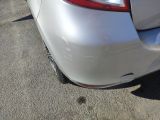 a white car parked in a parking lot next to other cars