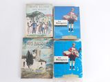 four books of french children ' s literature are on a white surface