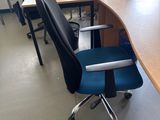 a desk with a chair and a computer on it