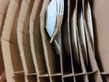 a cardboard box with a bunch of forks and spoons in it