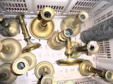 many different types of brass pipes in a white container