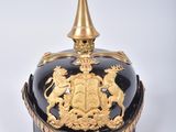 a black and gold helmet with a gold top
